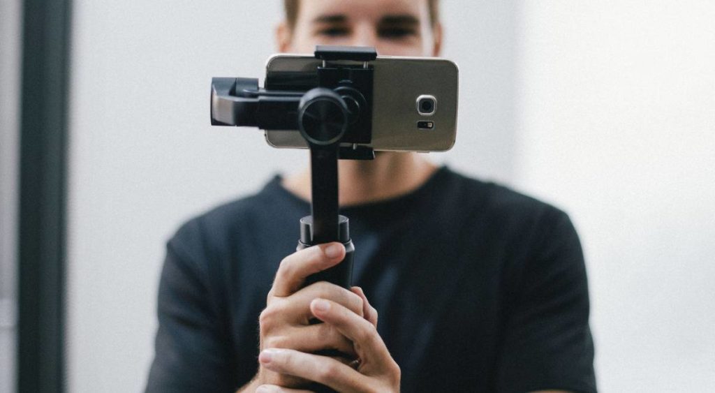 TV talent advocate holding gimbal to take selfie for TV show marketing