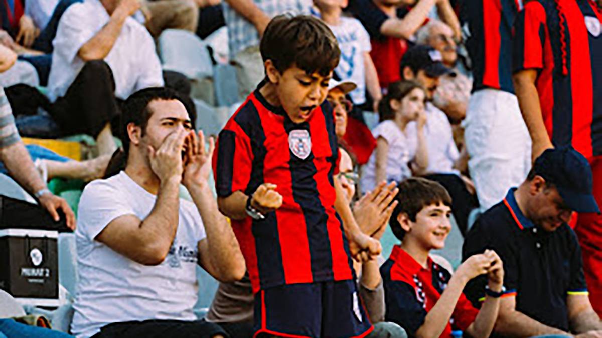 Boy cheering his favorite team demonstrating Gen Z sports fan engagement