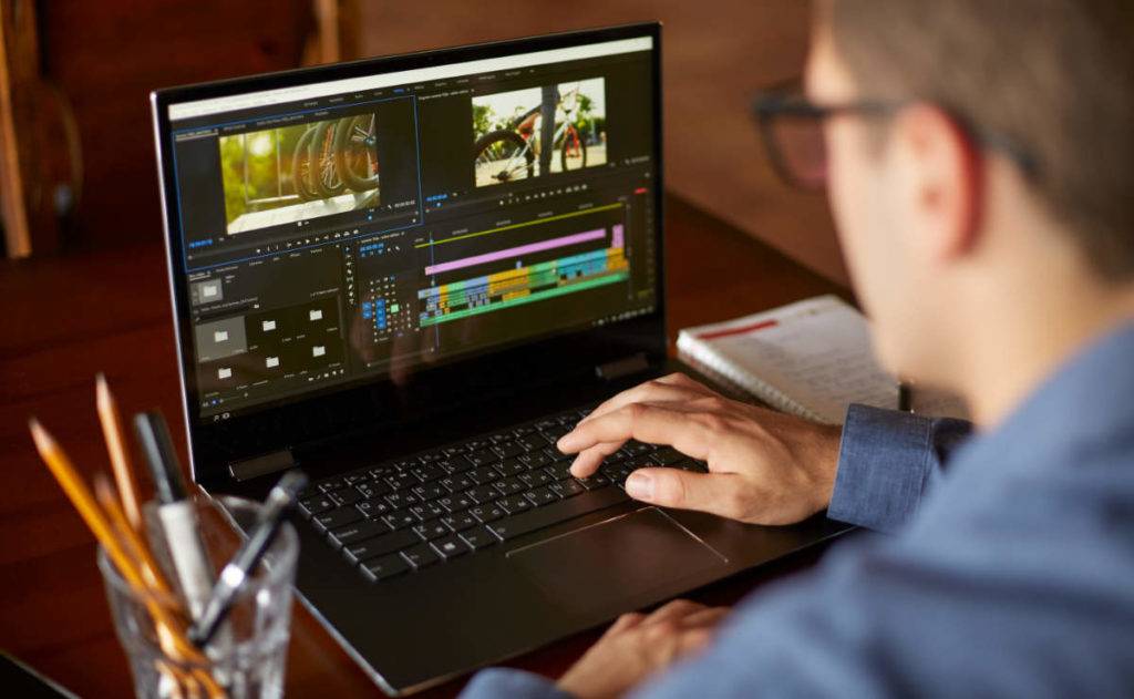 Video editor at laptop working on digital media storage