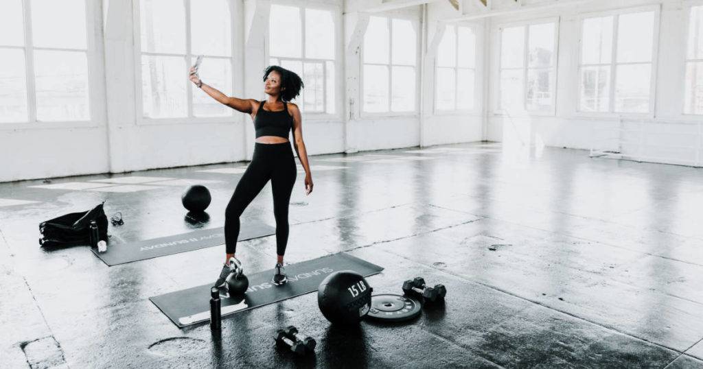 valuable-user-generated-content woman taking selfie in gym